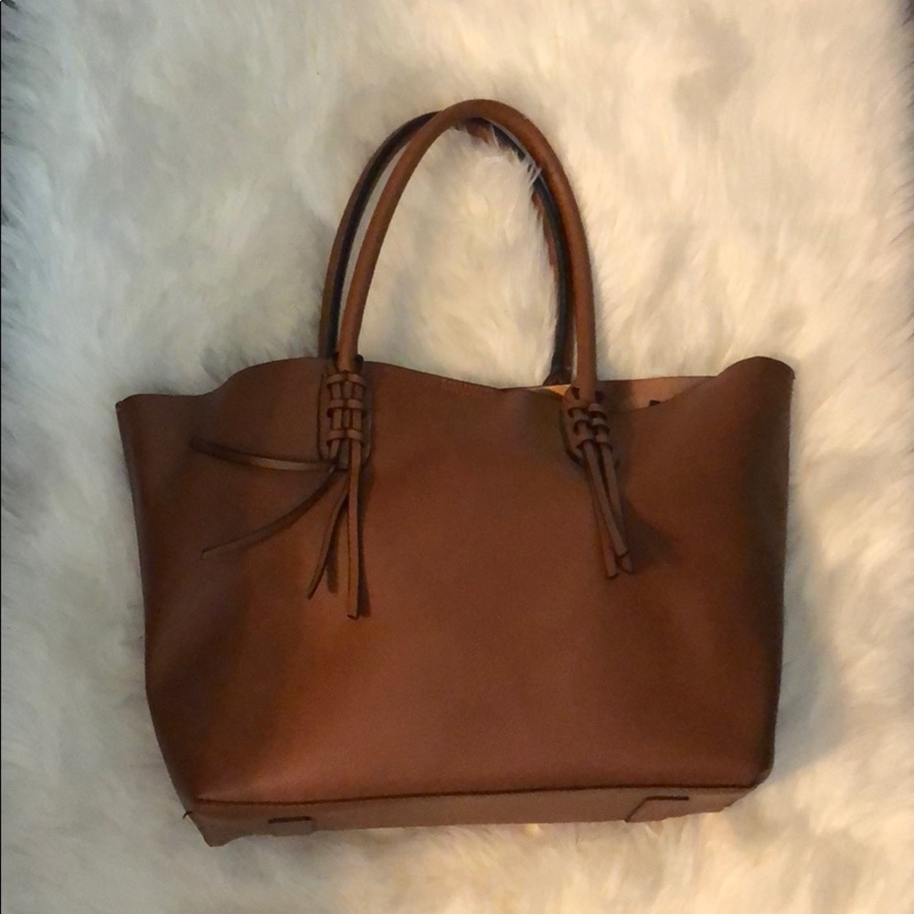 Tan large snap closure tote bag.